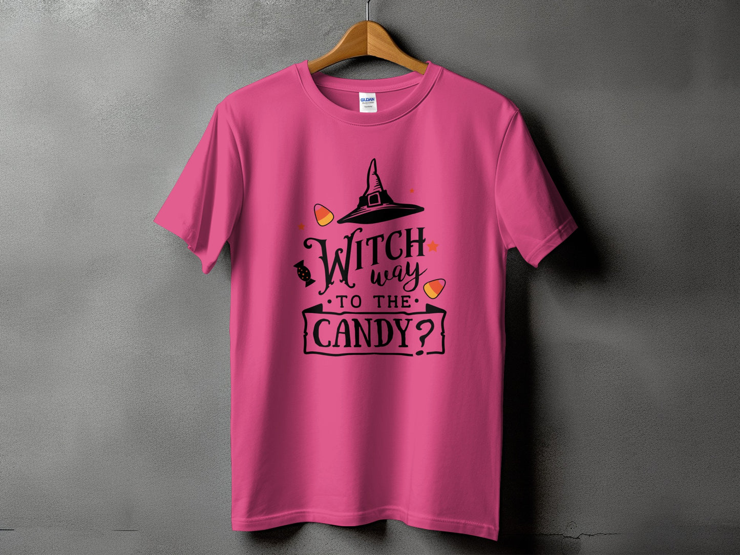 Pink t-shirt with Halloween design: witch hat, candy corn, and "Witch way to the candy?" text.
