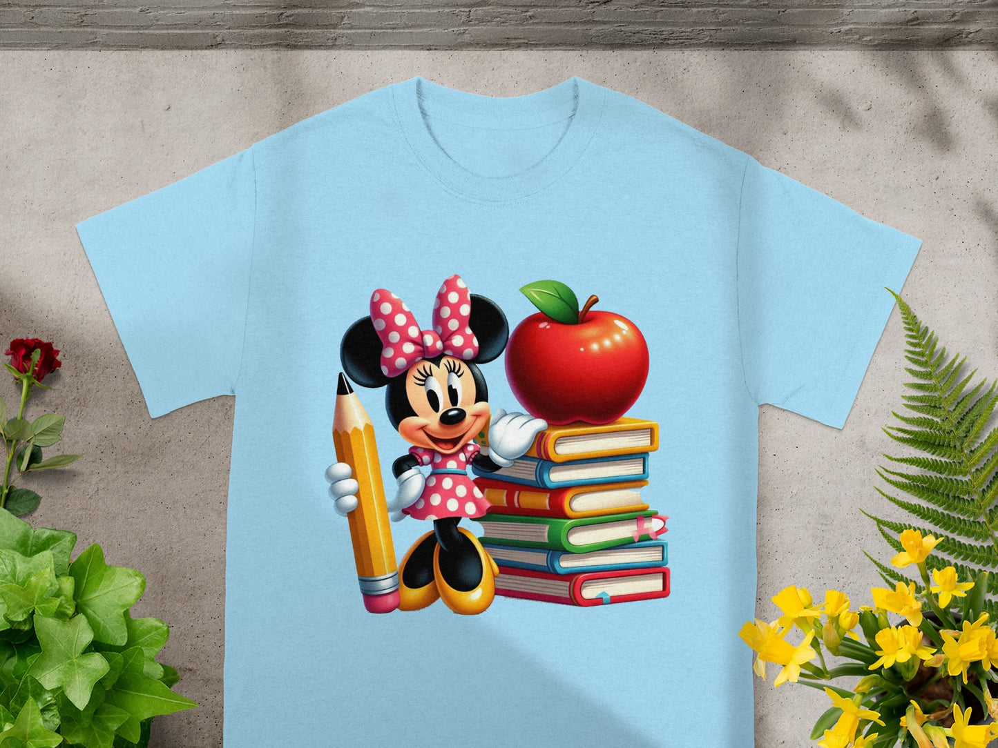Minnie Mouse holding a pencil next to stack of books and an apple.