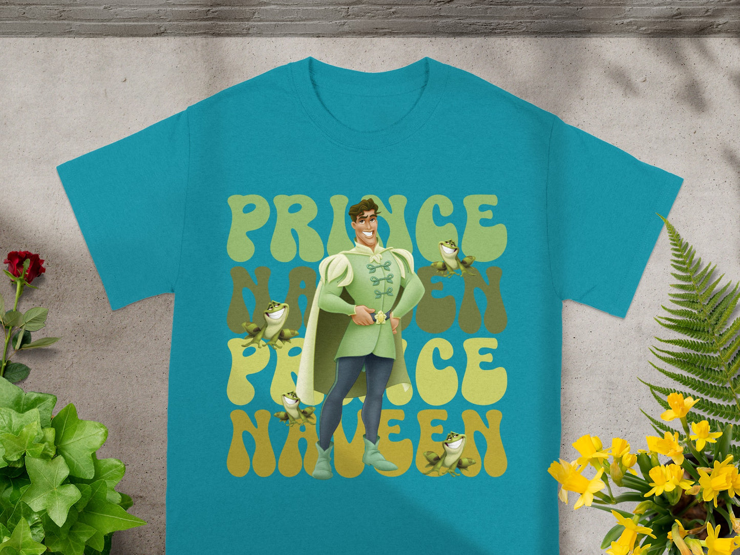 Teal t-shirt with Prince Naveen and green frog graphic and text.
