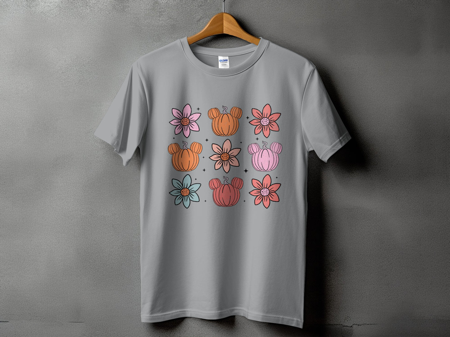 Gray t-shirt with a grid of colorful flowers and Mickey Mouse-shaped pumpkins.
