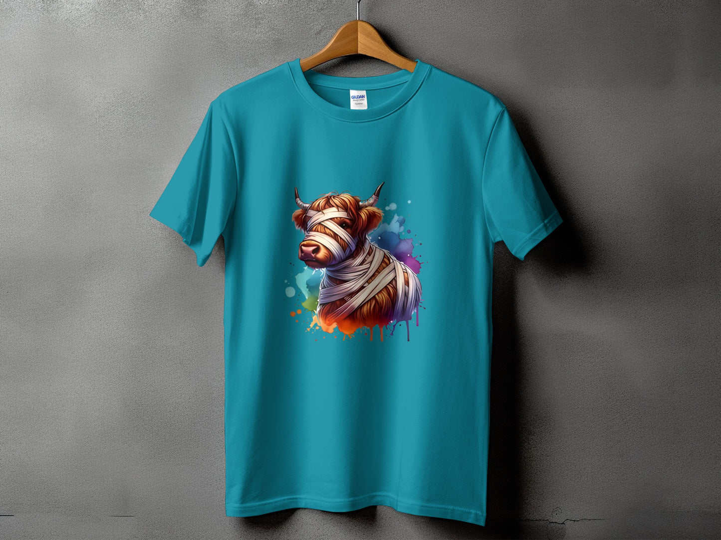 Teal t-shirt with a mummy cow graphic and watercolor splatters.