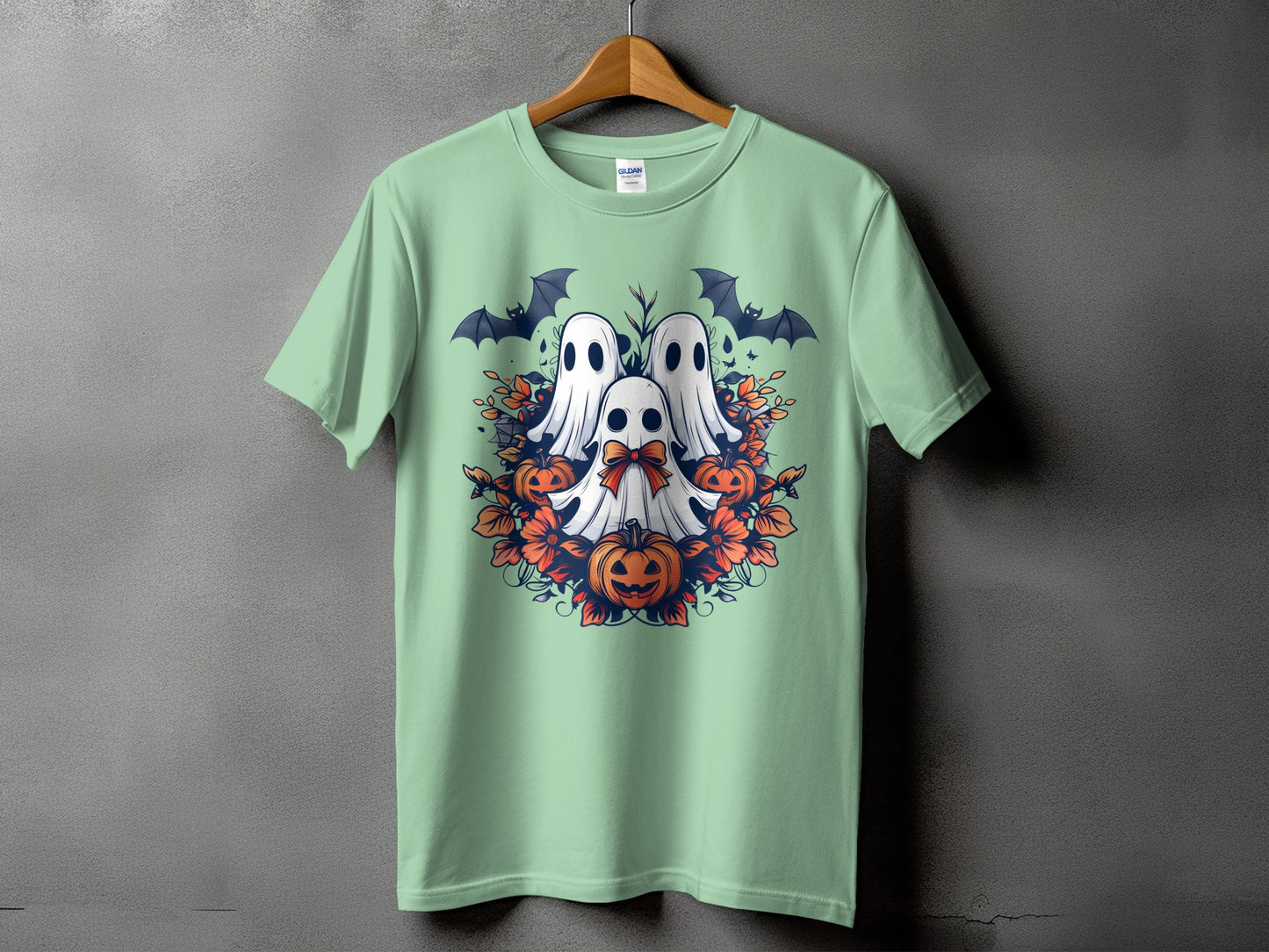 Mint green t-shirt with Halloween ghosts, pumpkins, bats, and floral accents.