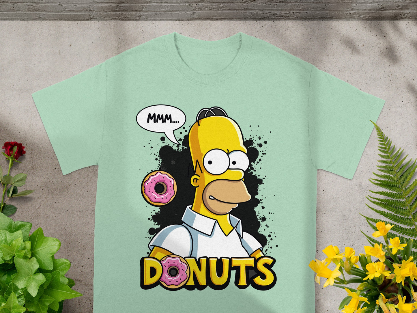 Homer Simpson saying "Mmm..." with donuts on a light green t-shirt.