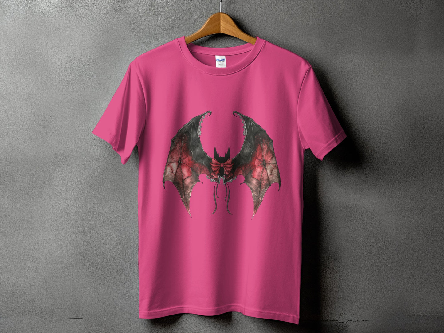 Pink t-shirt with a detailed drawing of bat wings with a red bow.