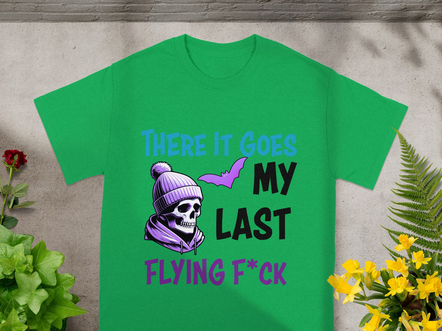 Green t-shirt with skull wearing beanie, bat, and text "There it goes my last flying f*ck."