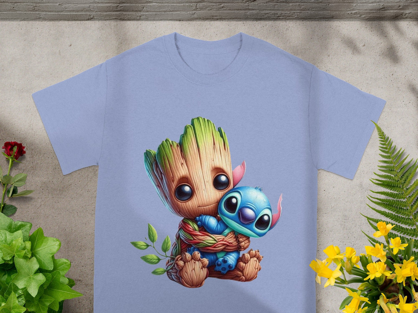 Groot hugging Stitch on a light blue t-shirt.