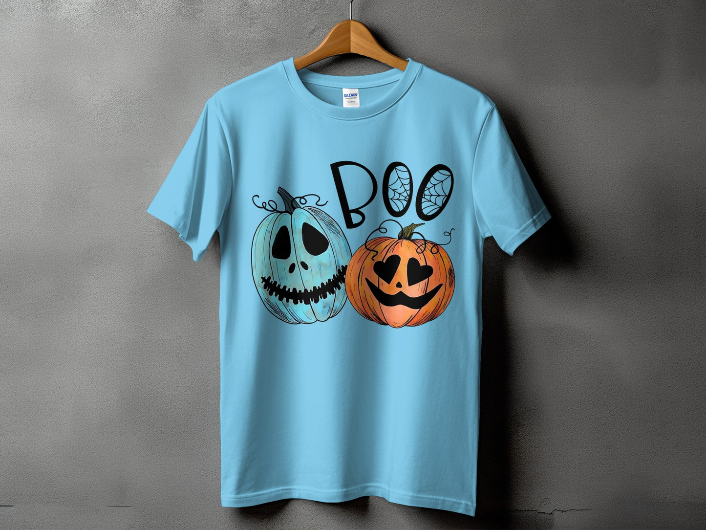 Light blue t-shirt with black text "BOO" and two Halloween pumpkins.