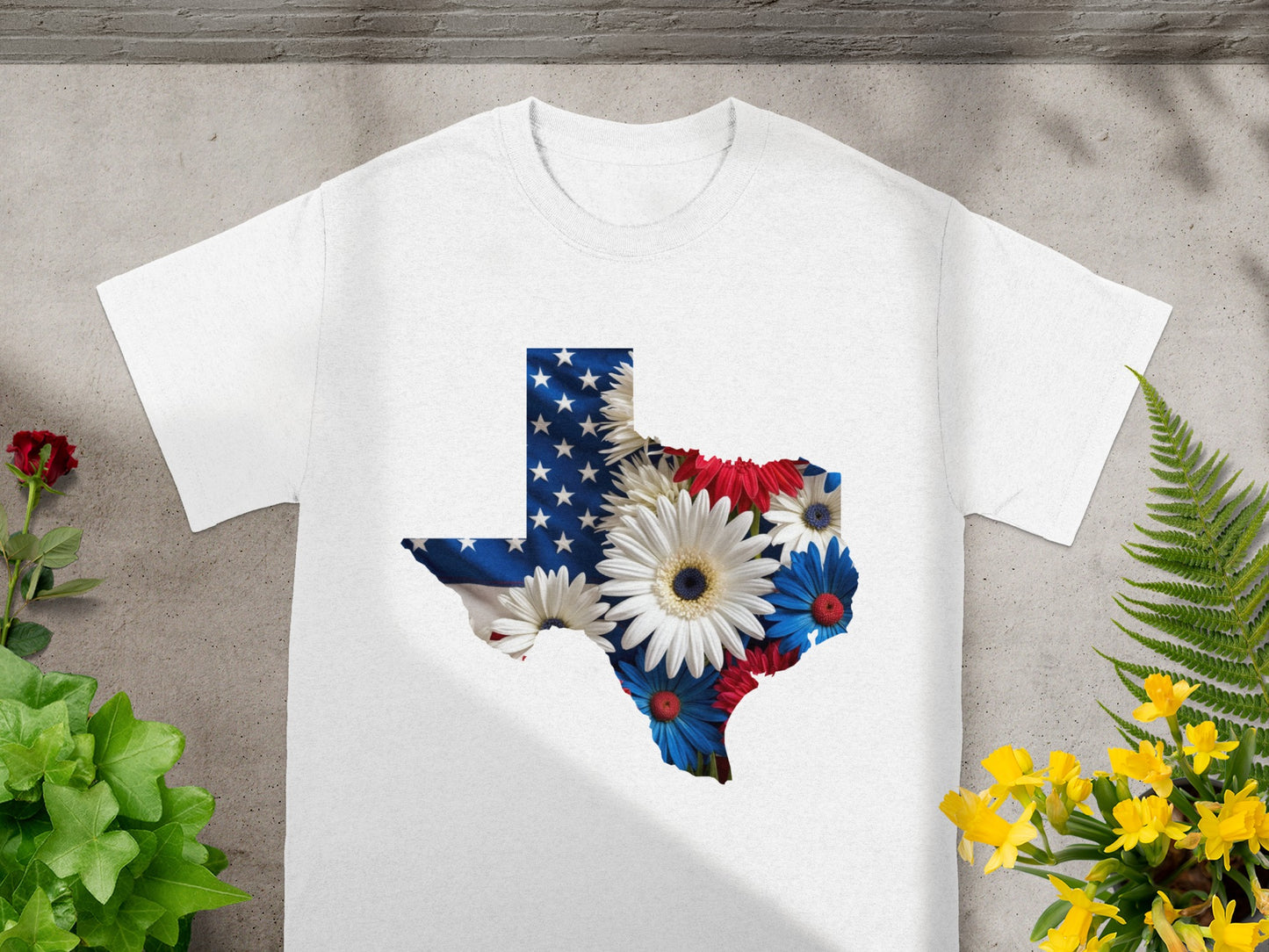 White t-shirt with Texas outline filled with American flag and flowers.