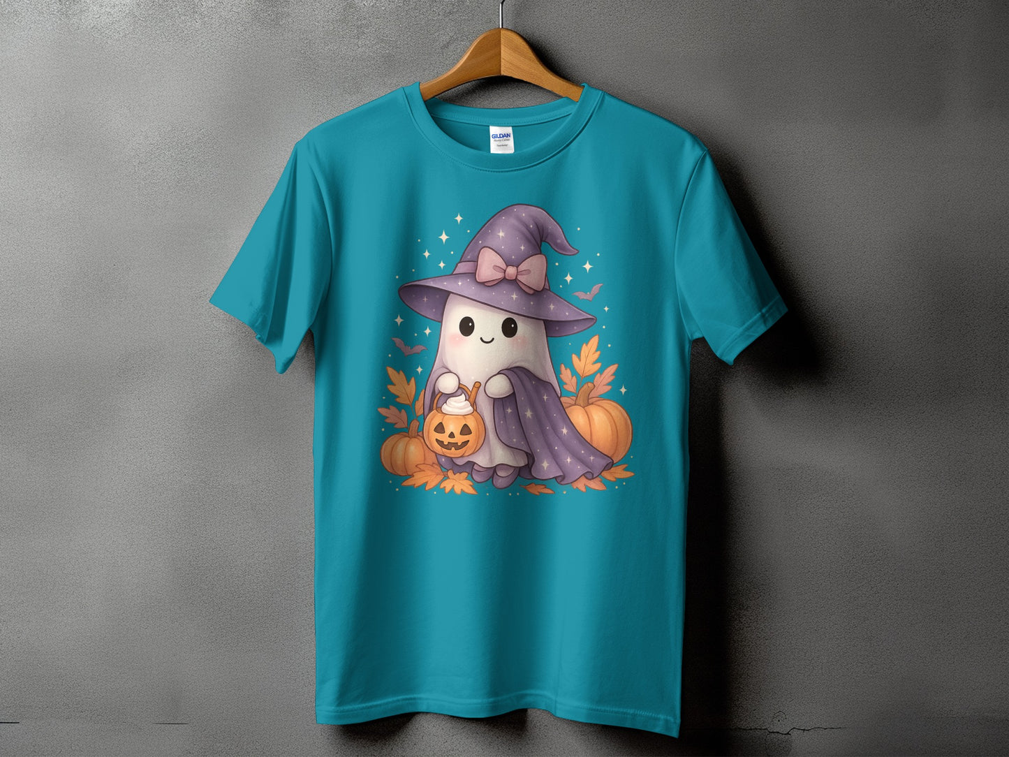 Teal t-shirt with a cute ghost wearing a witch hat holding a pumpkin.