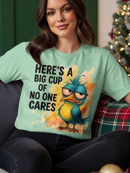T-shirt with a grumpy blue bird illustration and text "Here's a big cup of no one cares".