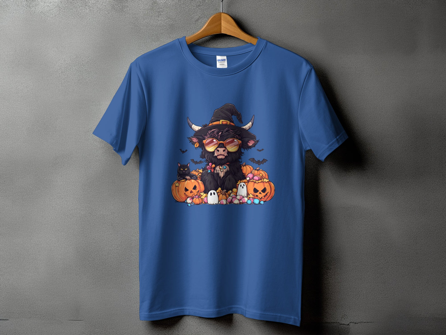 Halloween highland cow with sunglasses and hat surrounded by pumpkins and ghosts.