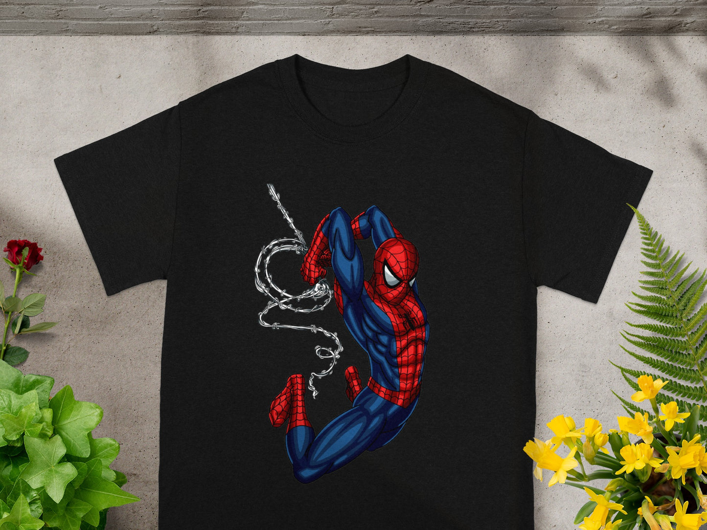 Black t-shirt with Spider-Man in a dynamic pose, mid-air with webs.