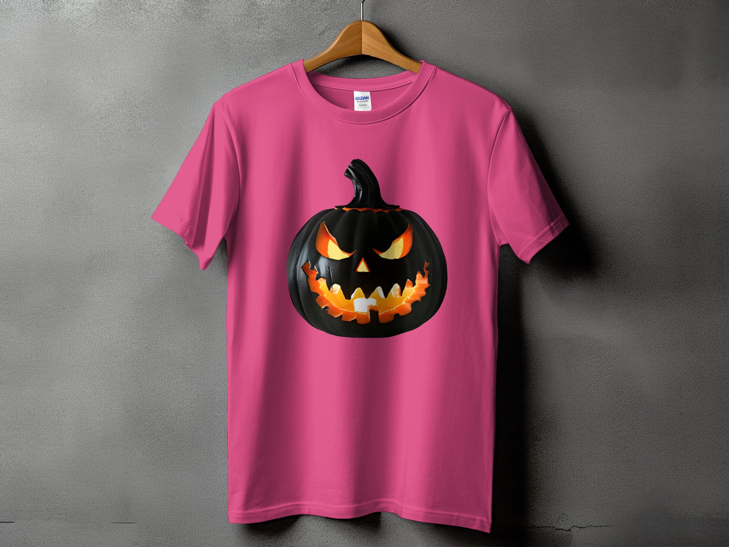 Pink t-shirt with a black, glowing jack-o'-lantern graphic on the front.