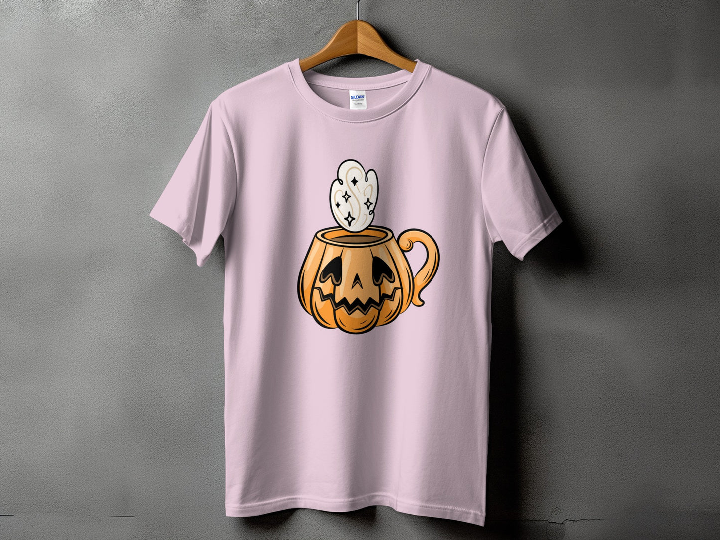 Pink t-shirt with a jack-o'-lantern mug with steam and stars graphic.