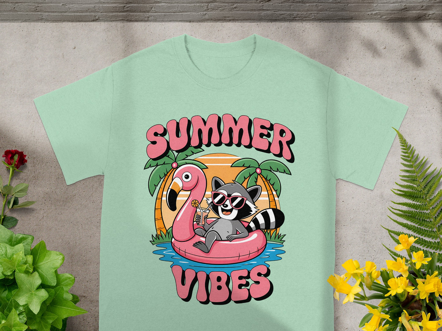 raccoon in pink flamingo float with sunglasses on t-shirt, says SUMMER VIBES
