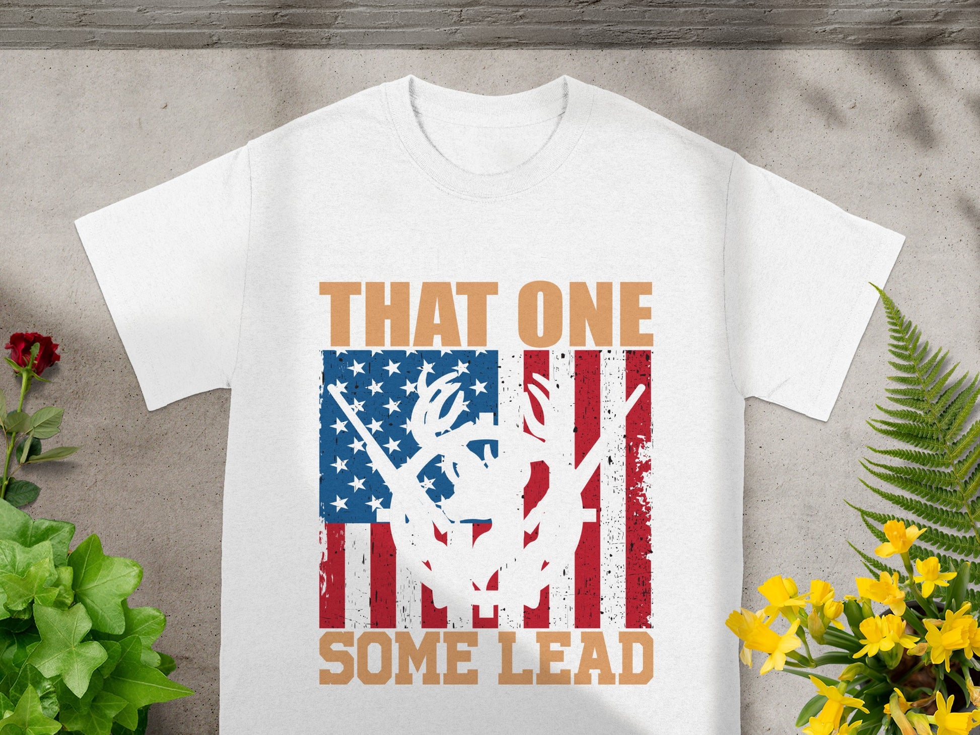 White t-shirt with American flag graphic, deer antlers, rifle, and text "THAT ONE SOME LEAD."