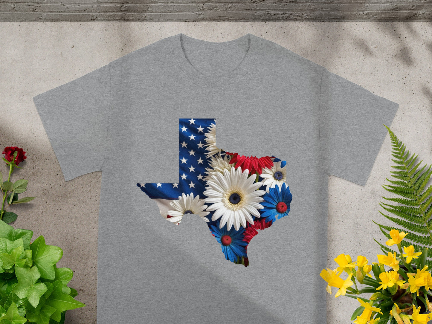 Texas outline filled with US flag and patriotic flowers on a grey t-shirt.