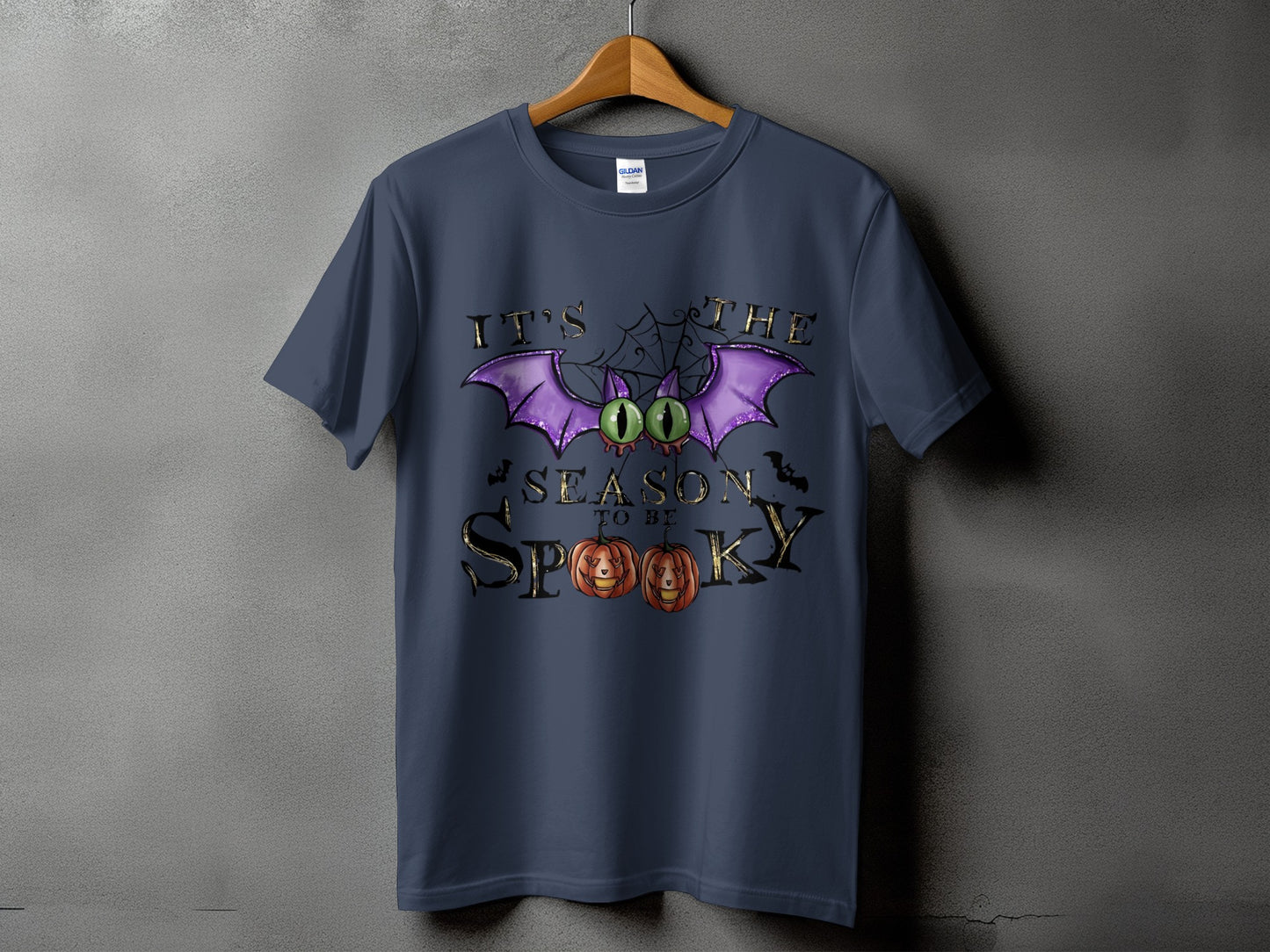 Dark blue t-shirt with "It's the Season to be Spooky" and Halloween graphics.