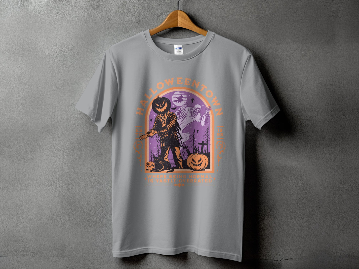 Grey t-shirt with Halloween graphic of scarecrow, ghost, and pumpkins with text.