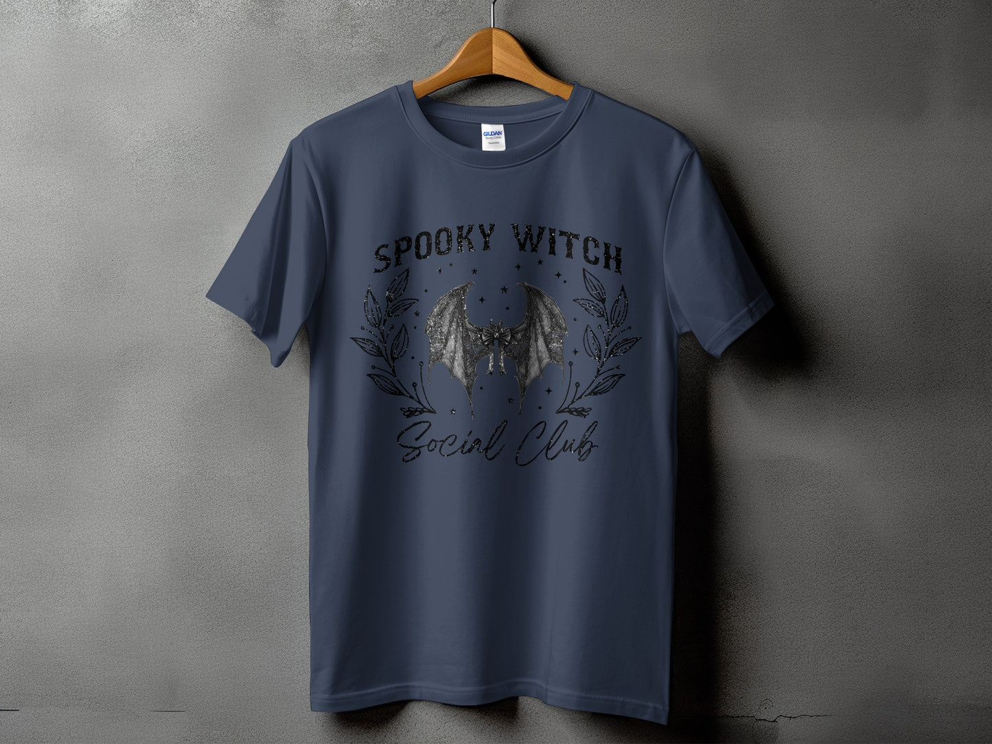 Dark blue t-shirt with "Spooky Witch Social Club" text and bat graphic.