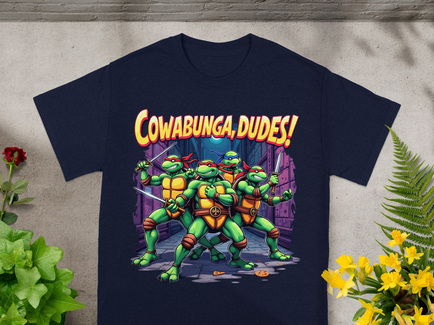 Teenage Mutant Ninja Turtles with "Cowabunga, Dudes!" text on a dark blue t-shirt.