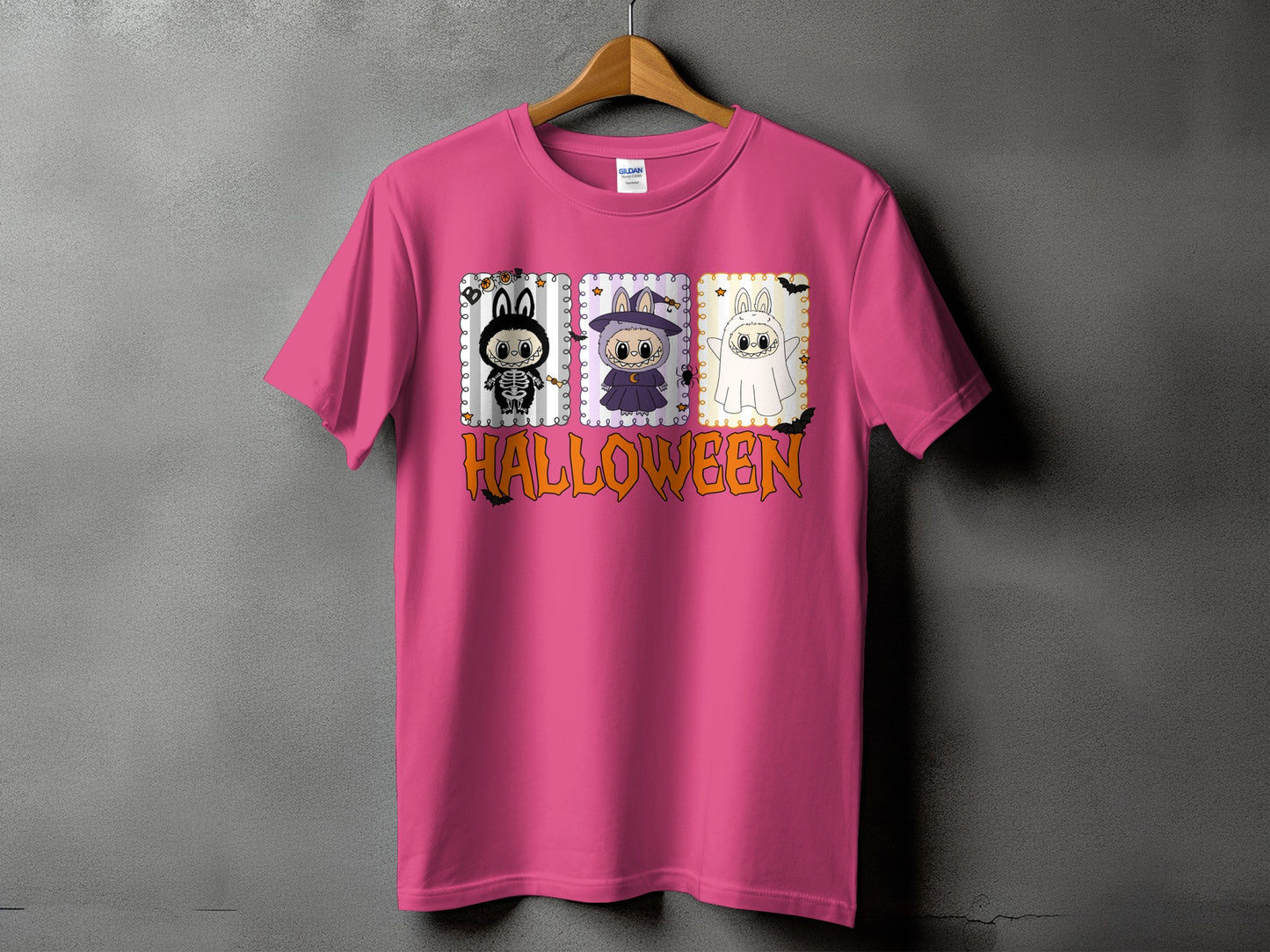 Pink t-shirt with three cute Halloween characters and the word "HALLOWEEN" in orange.