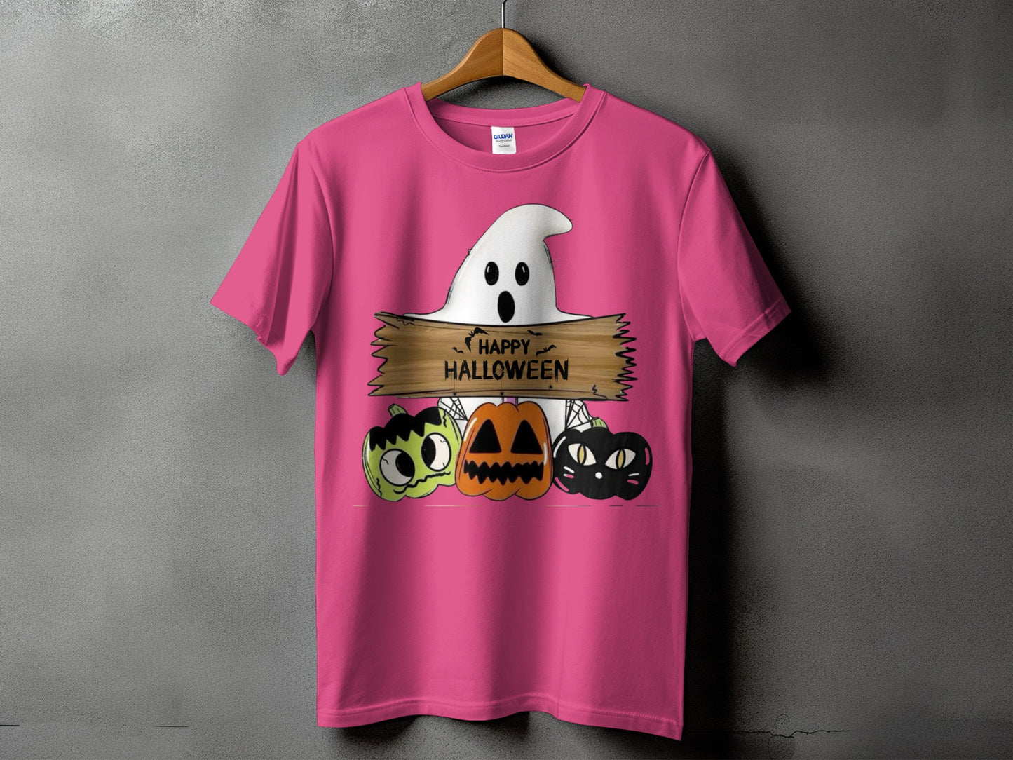 Pink t-shirt with a ghost, pumpkins, and black cat graphic saying "Happy Halloween".
