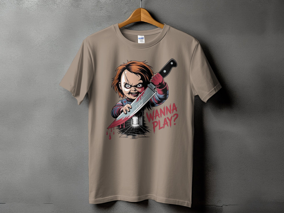 Chucky doll with knife and "WANNA PLAY?" text on tan t-shirt.
