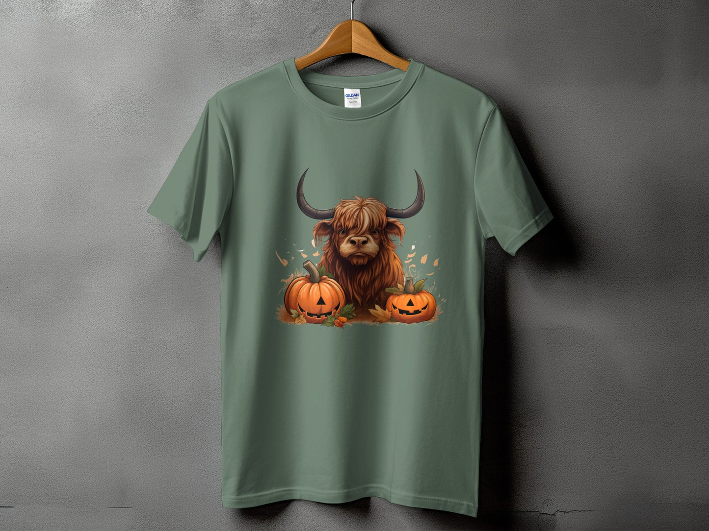 Green t-shirt with a Highland cow and pumpkins graphic.