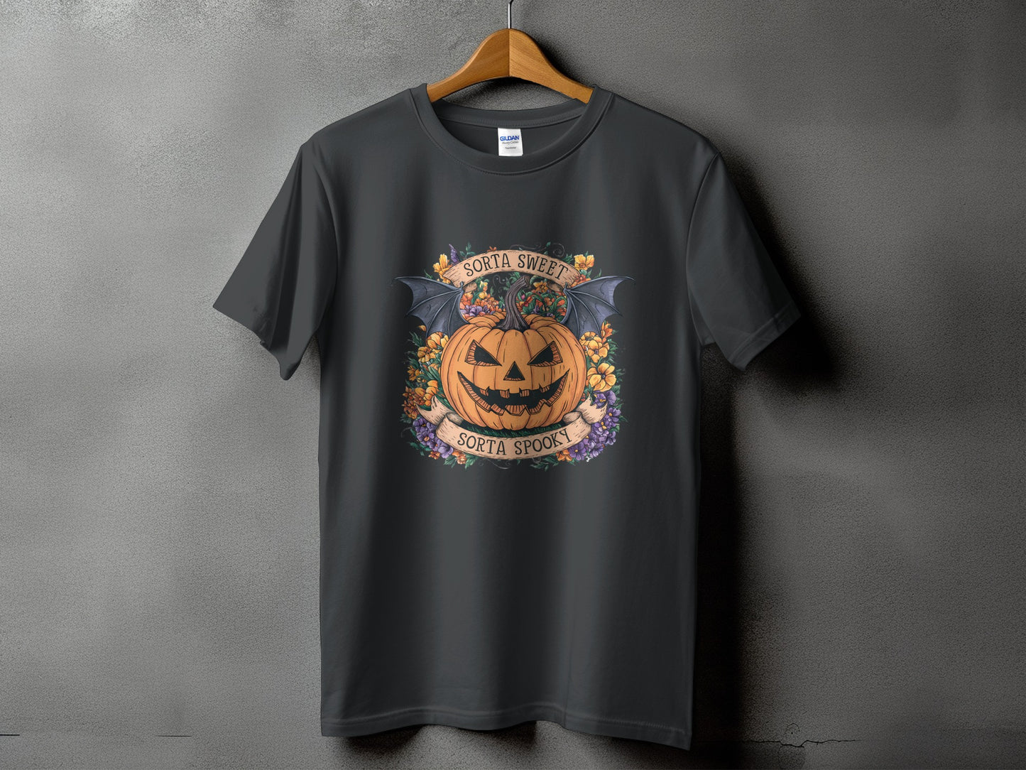Dark gray t-shirt with a Halloween design featuring a jack-o-lantern with bat wings and text.