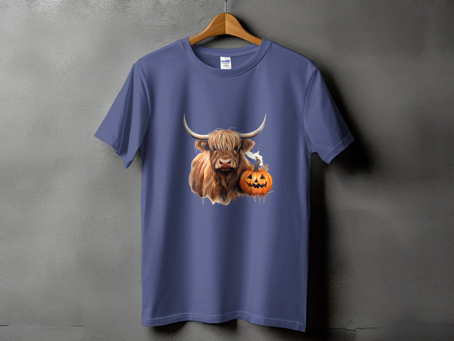 Purple t-shirt with a Highland cow and jack-o'-lantern graphic.