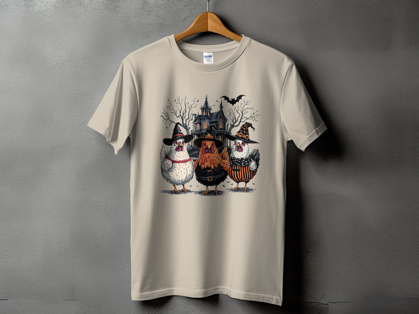 Three chickens in Halloween costumes stand before a spooky house with a bat.