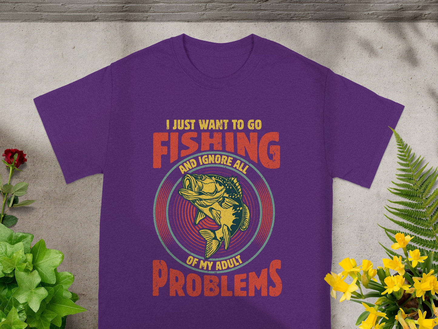 Purple T-shirt with fishing graphic and text "I JUST WANT TO GO FISHING AND IGNORE ALL OF MY ADULT PROBLEMS".