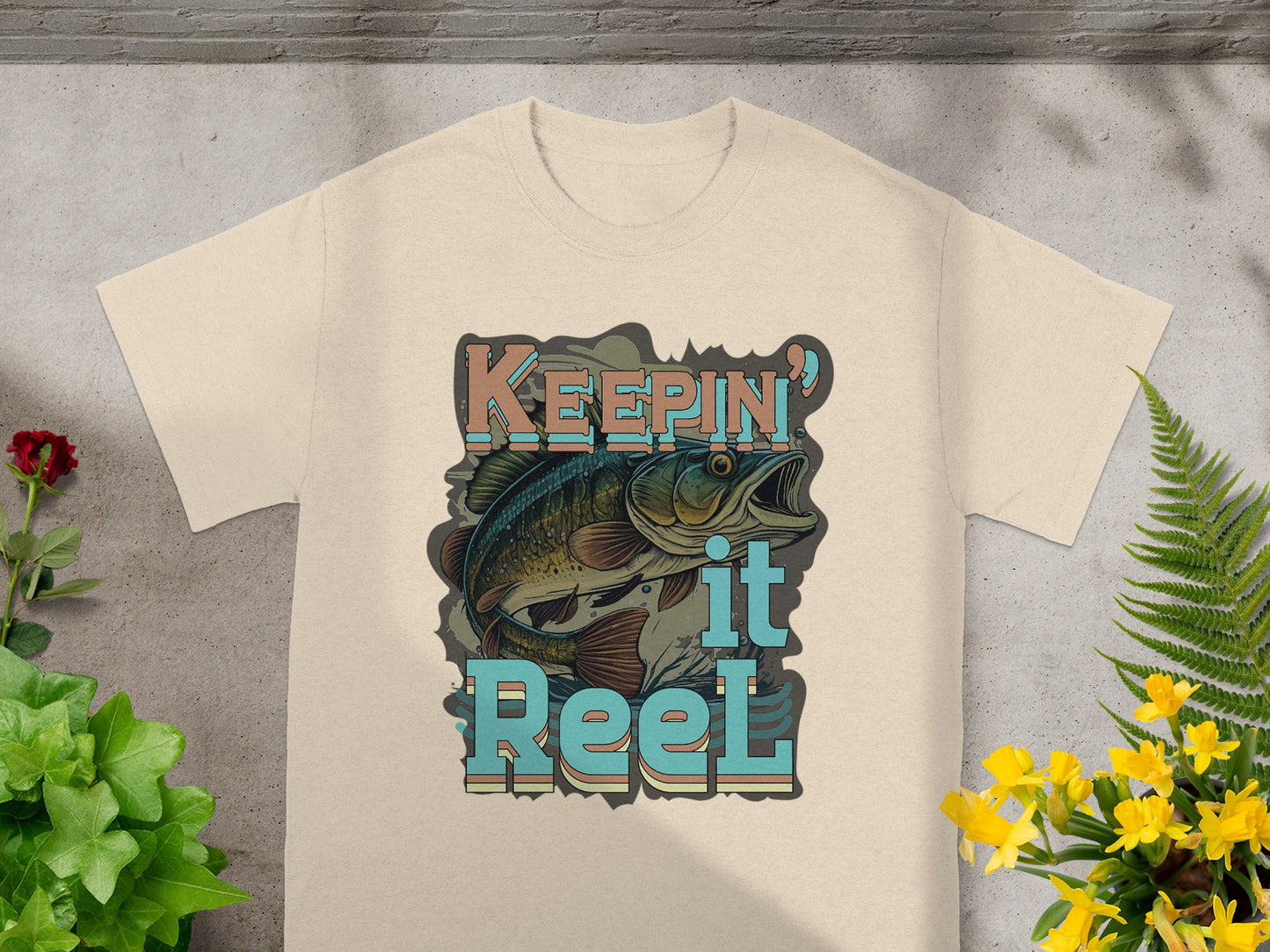 T-shirt with graphic of a jumping bass and text "Keepin' it Reel".