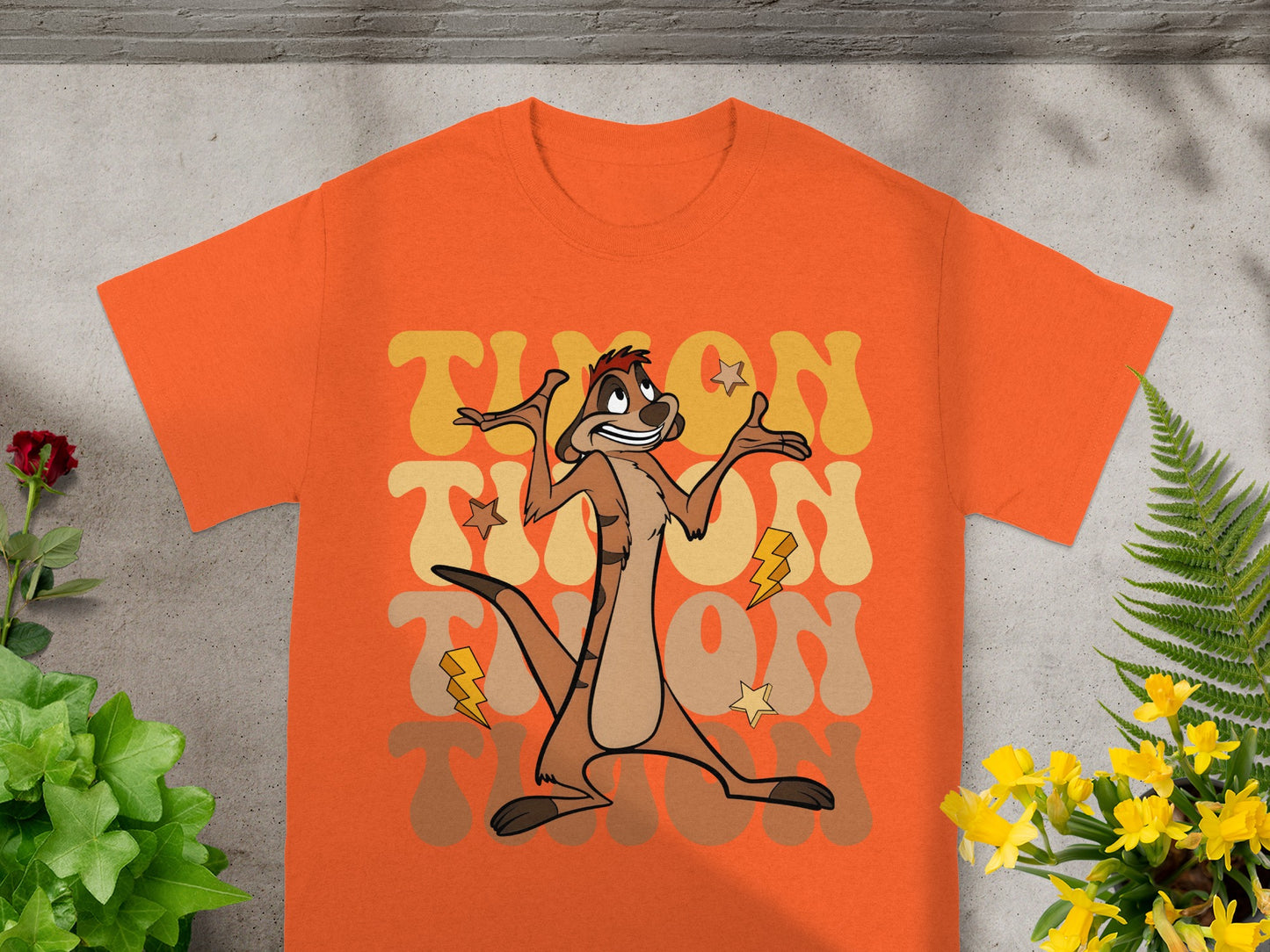 Orange t-shirt with Timon from The Lion King graphic and "Timon" text.