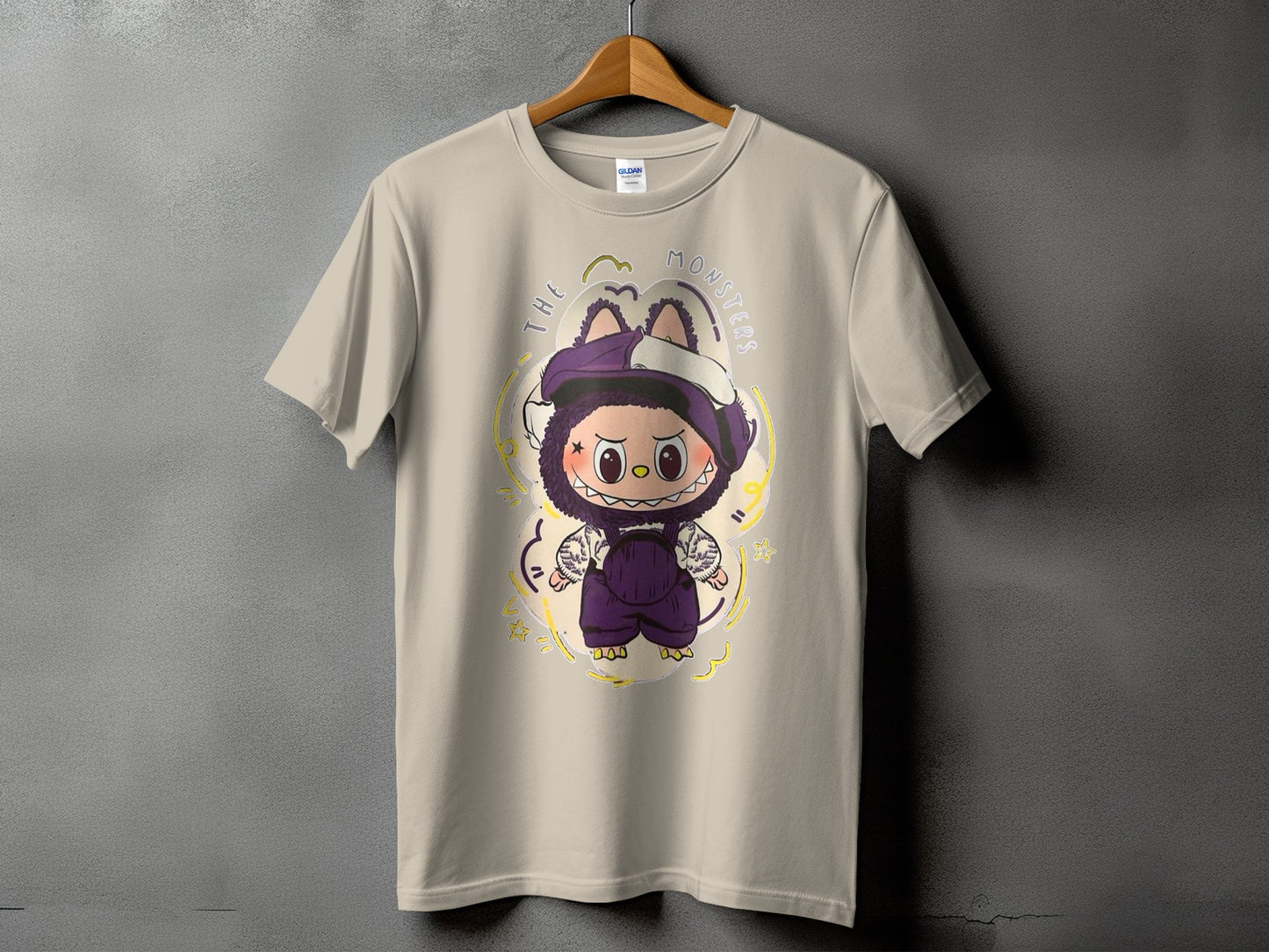 Tan t-shirt with a cartoon monster graphic and "THE MONSTERS" text.