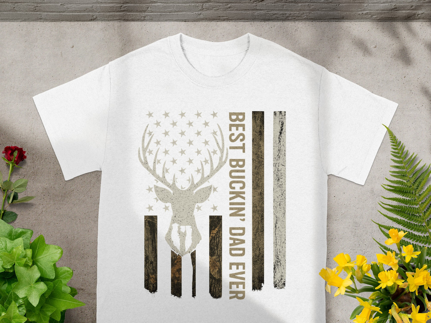 White t-shirt with deer antlers and stars forming an American flag and text.