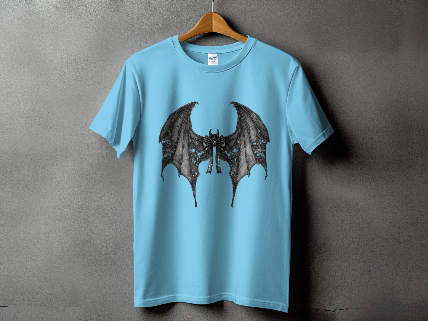 Light blue t-shirt with a black detailed bat wing design and a bow.