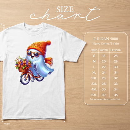 White t-shirt with cartoon ghost riding a bicycle with flowers. Size chart included.