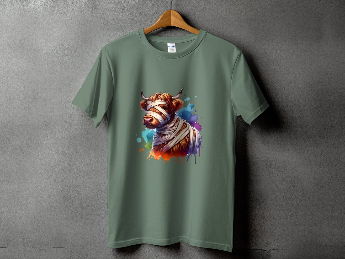 Highland cow wrapped in bandages, with colorful paint splatter on a green t-shirt.