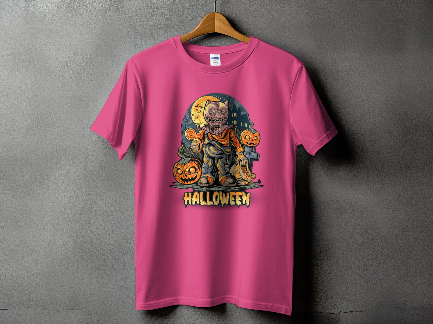 Pink t-shirt with Halloween graphic of a scarecrow character holding a lollipop.