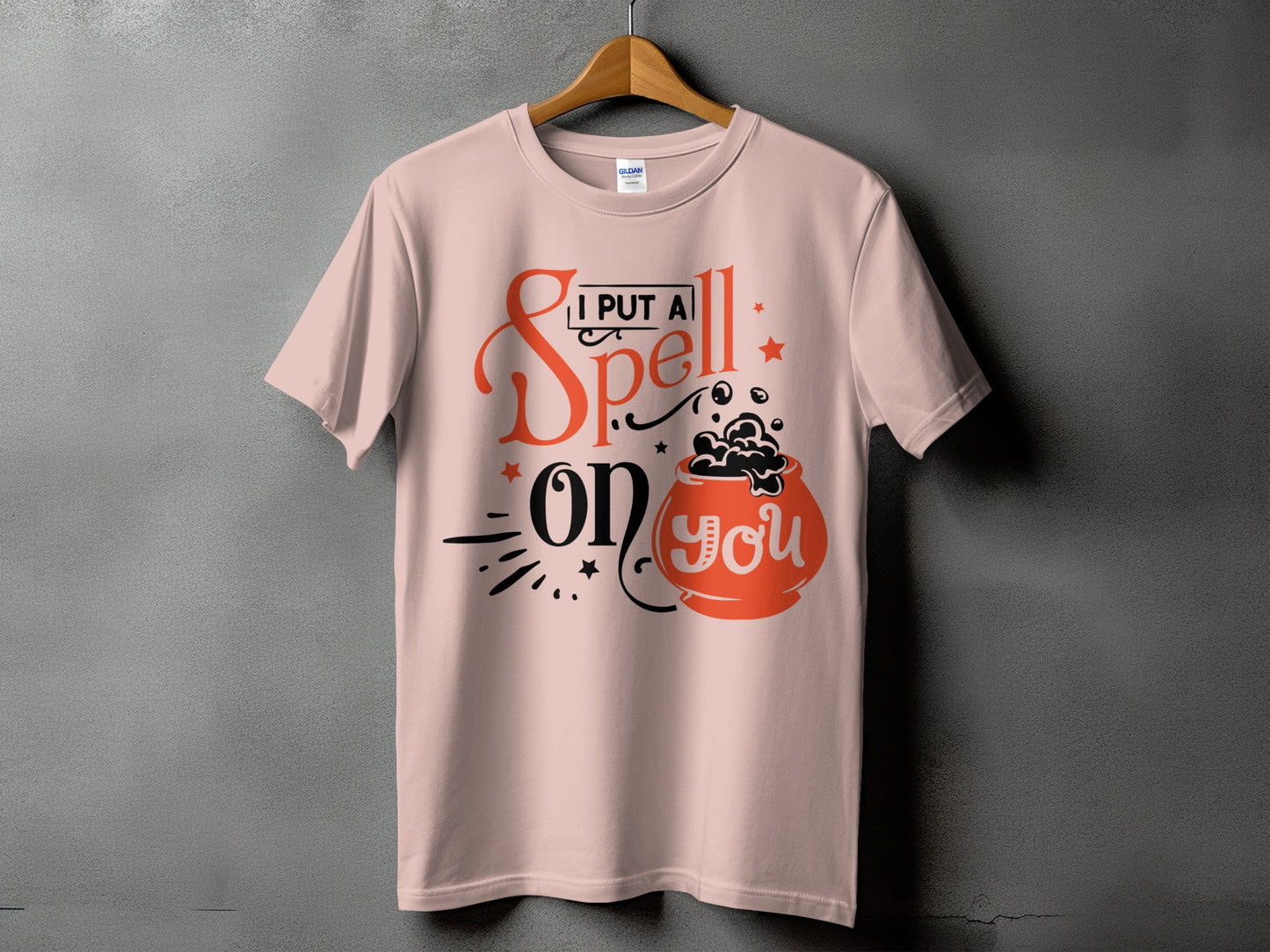 Pink t-shirt with "I put a spell on you" and cauldron graphic.