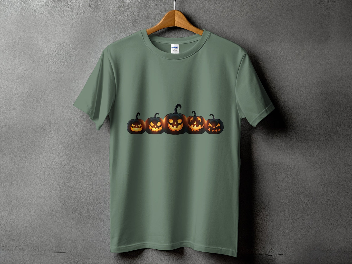 Green t-shirt with a row of five glowing jack-o'-lanterns across the chest.