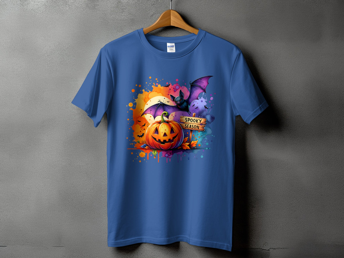 Blue t-shirt with a Halloween graphic featuring a pumpkin, bat, and "Spooky Season" sign.