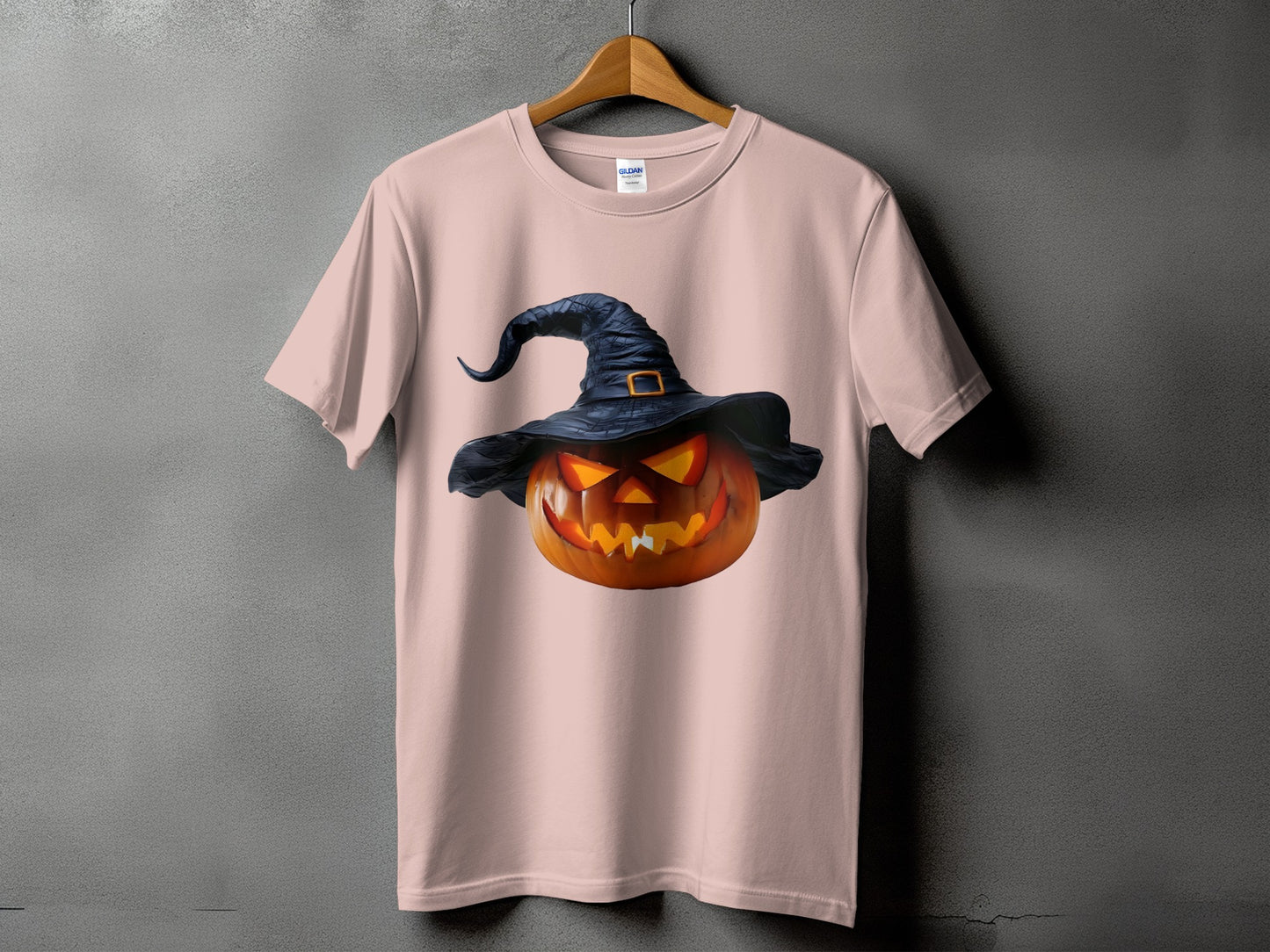 Pink t-shirt with a glowing jack-o'-lantern wearing a witch hat.