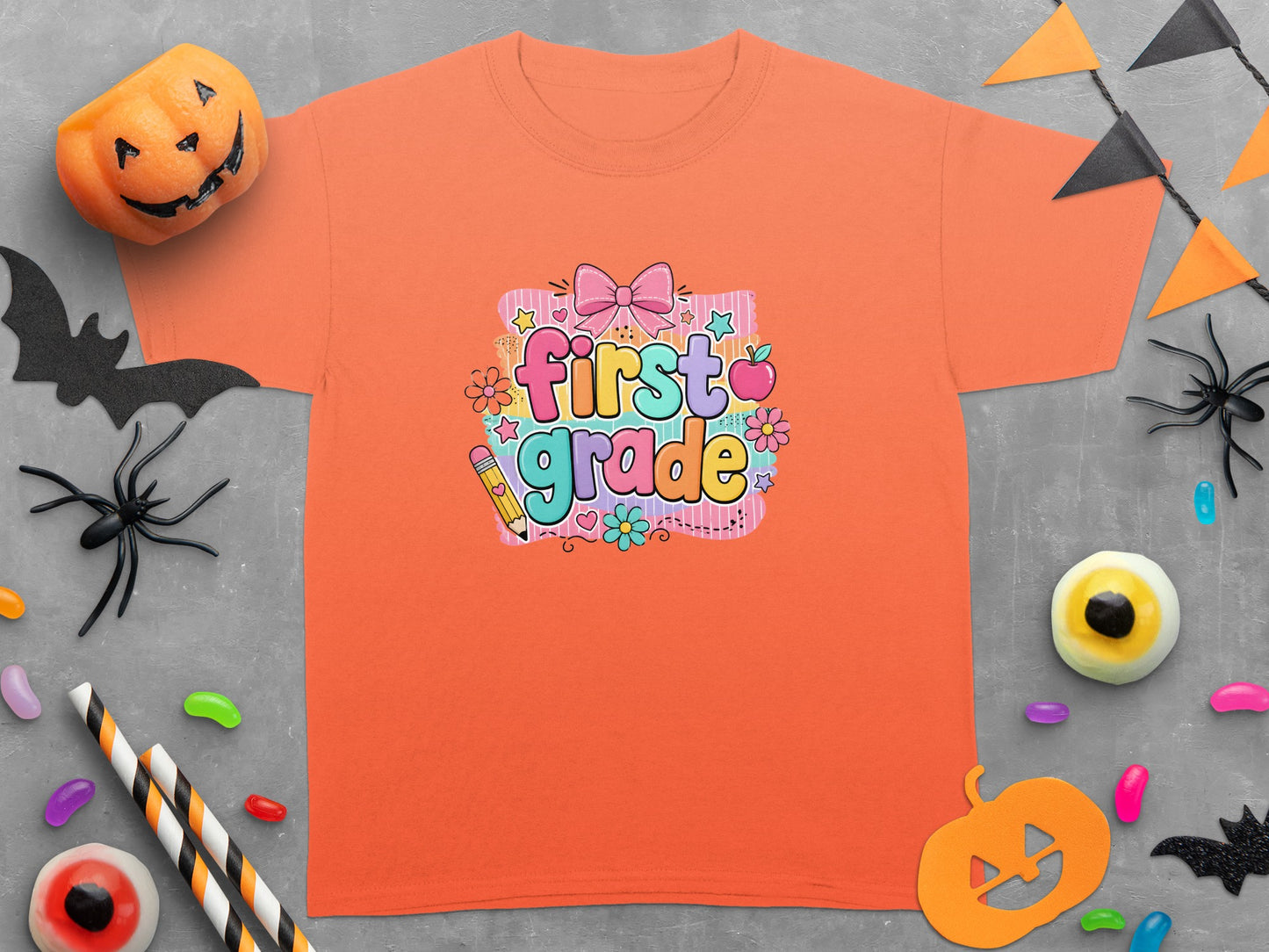 Orange t-shirt with "first grade" text and Halloween decorations.