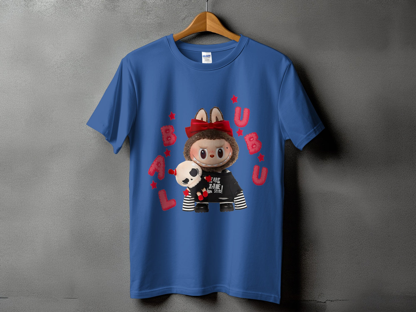 Blue t-shirt with graphic of fuzzy character holding skull, red text and stars.