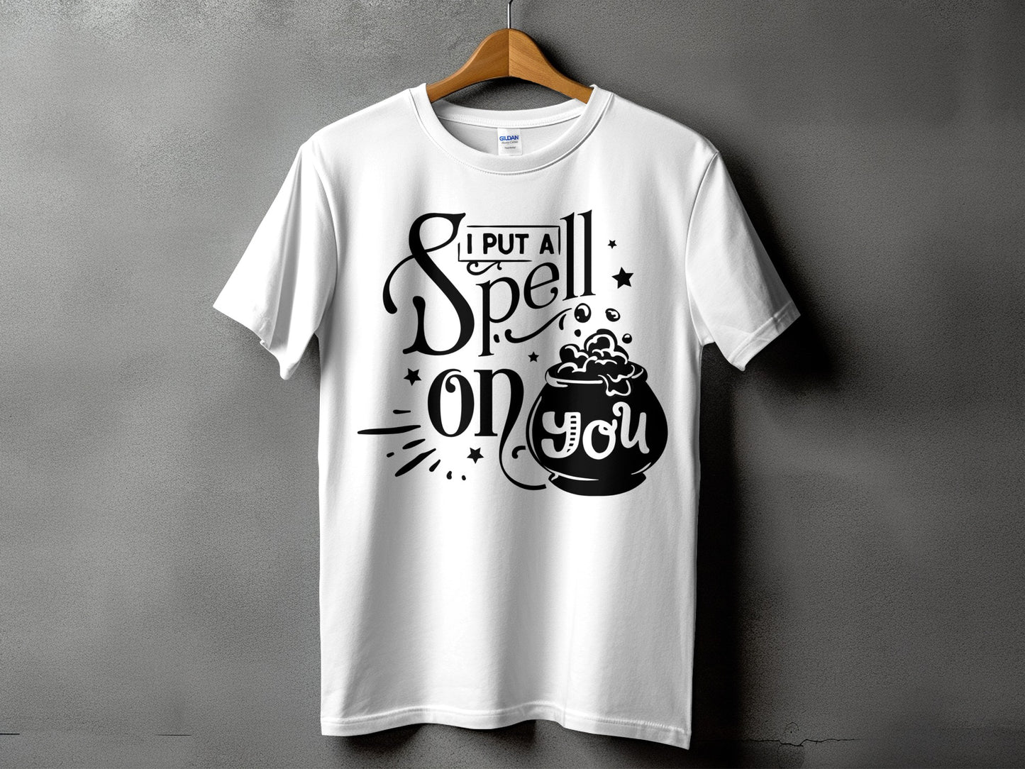 White t-shirt with black text and cauldron graphic: "I put a spell on you".