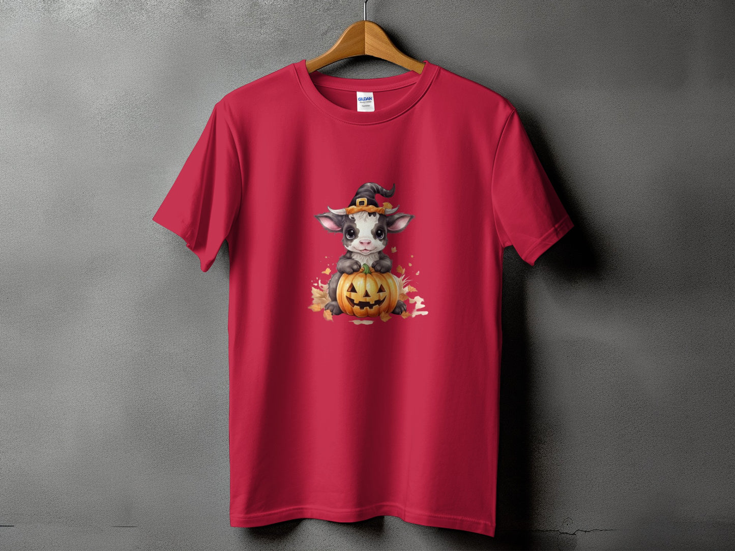 Red t-shirt with a cute cow in a witch hat and pumpkin Halloween graphic.