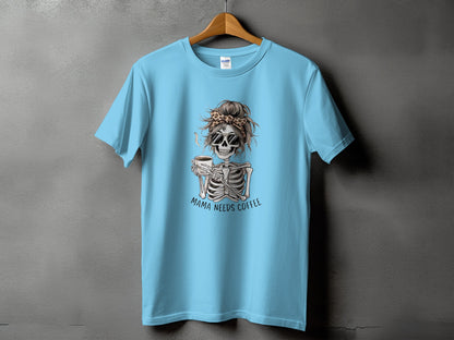 Light blue t-shirt with a skeleton graphic drinking coffee, text "Mama Needs Coffee."